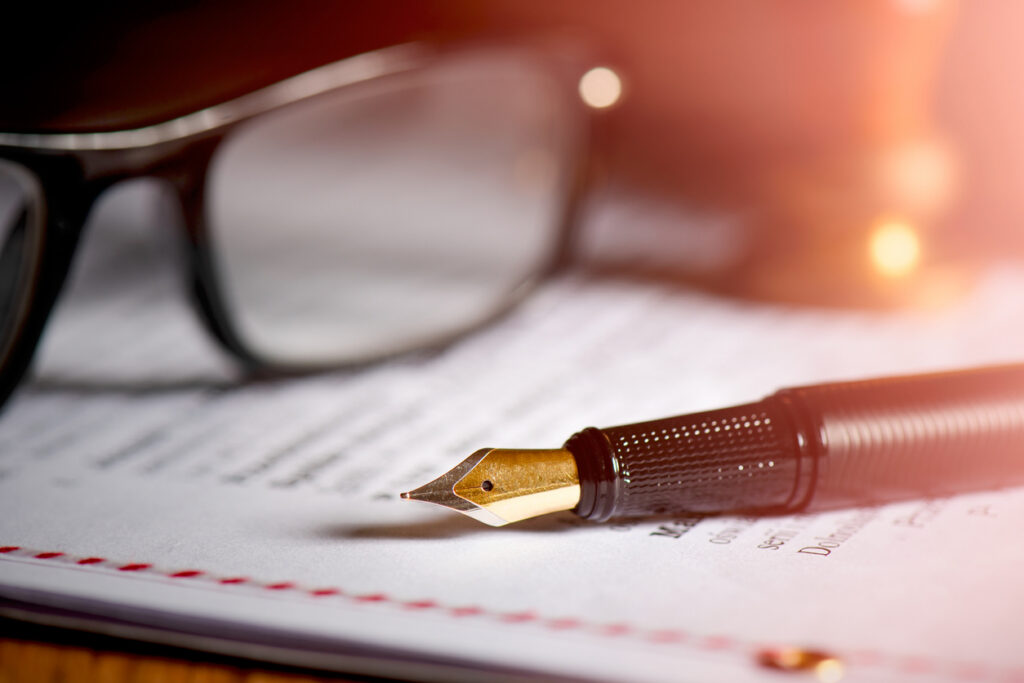 Organised contract documents on an executive desk representing a Binding Financial Agreement in NSW family law